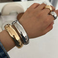 Irregular Metal Wide Curved Glossy Spring Bracelet - Norellé